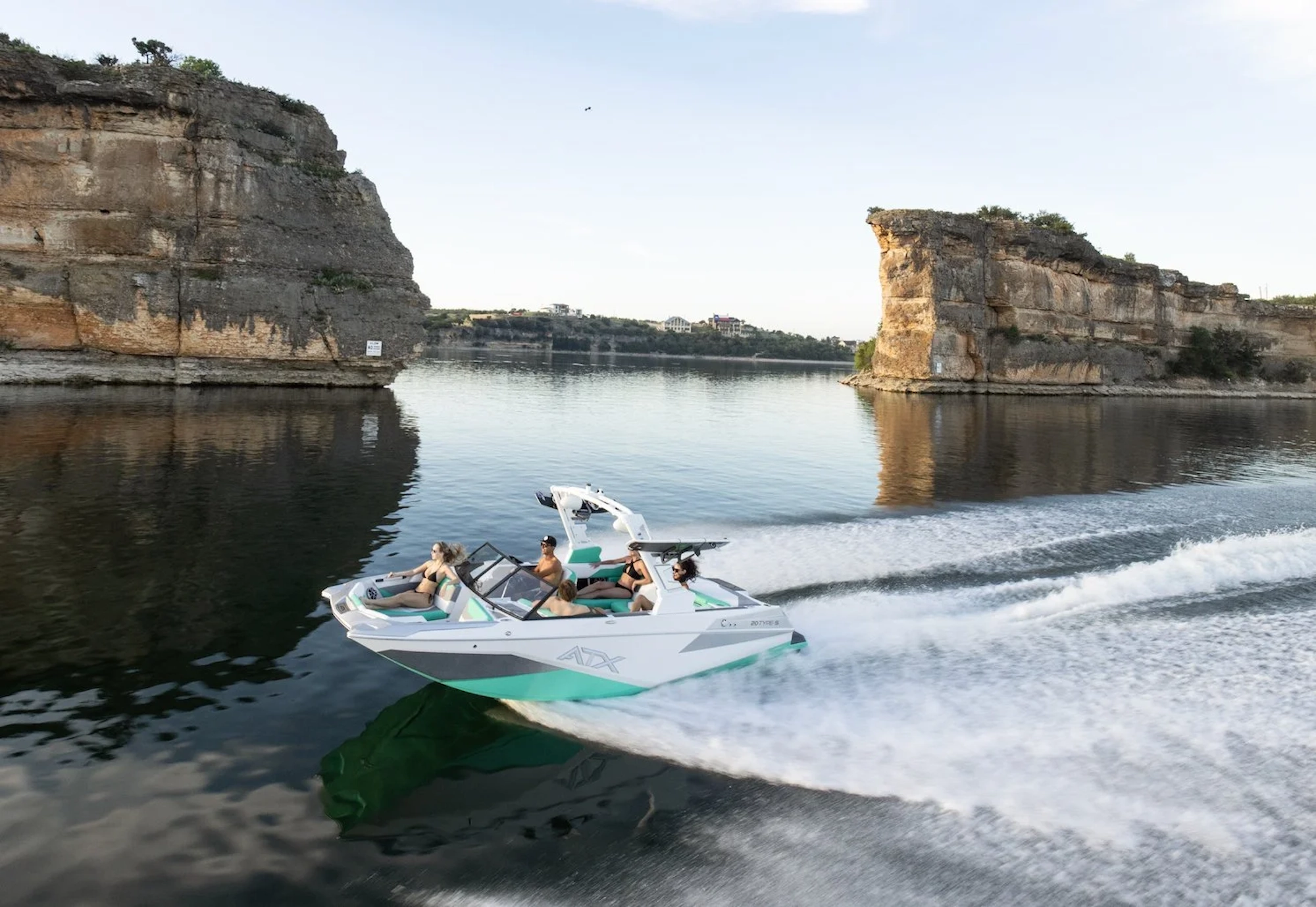 ATX boat cruising between rocky cliffs